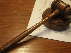 A gavel on top of a legal document.