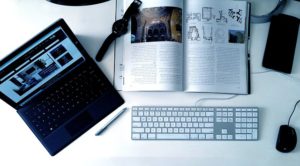 computer and magazine on a desk