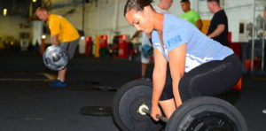 woman lifting weights at gym